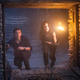 Tom Holland as Nathan Drake and Sophia Taylor Ali as Chloe Frazer explore a cavern in the Uncharted movie.